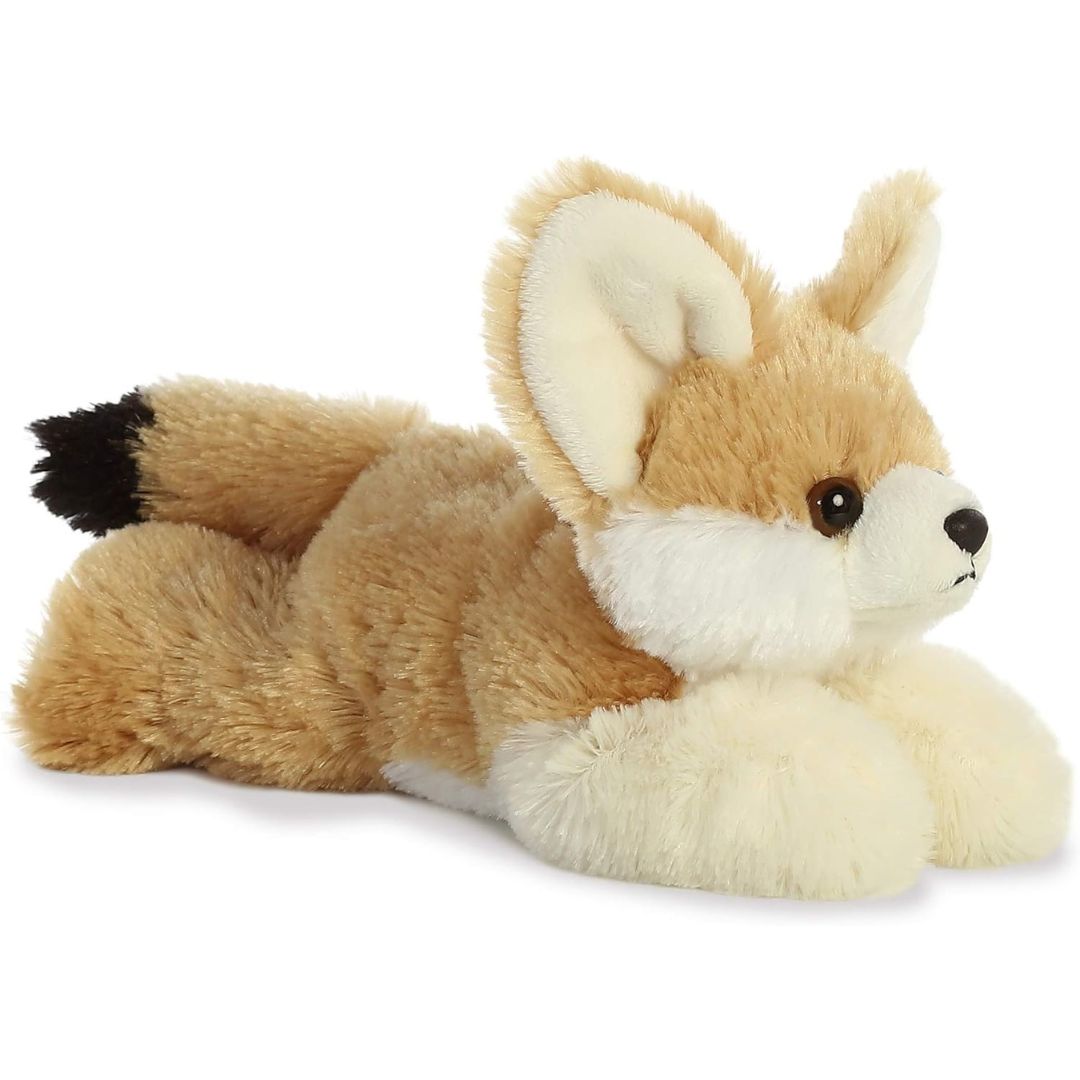 Angled side view of the Aurora Mini Flopsie Frisky Fennec Fox 8-inch plush resting on its belly, featuring large alert ears and a black-tipped tail.