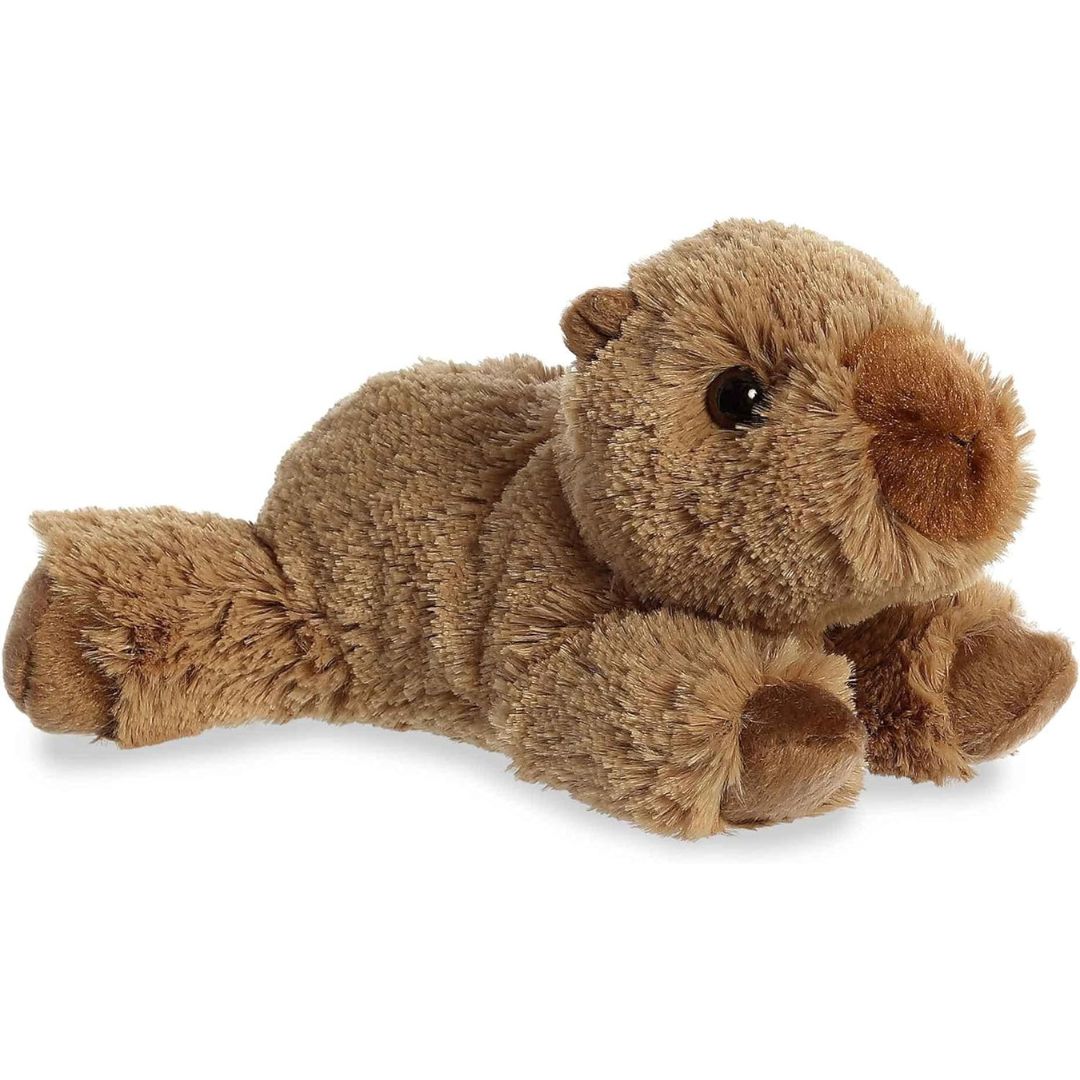 Side angle showing the unique floppy resting pose of the Aurora Charlie Capybara plush toy.