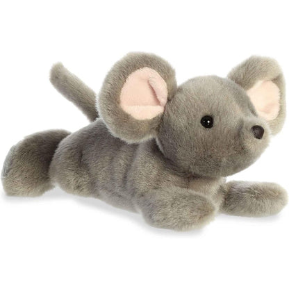 Angled side view of the Aurora Mini Flopsie Missy Mouse 8-inch plush resting on its belly, featuring soft grey fur and large ears.