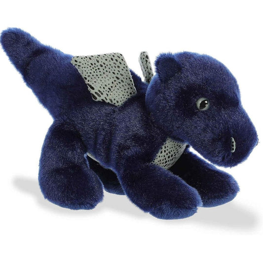 Angled side view of the Aurora Mini Flopsie Sapphire Dragon 8-inch plush resting on its belly, featuring deep blue fur and silver wings.