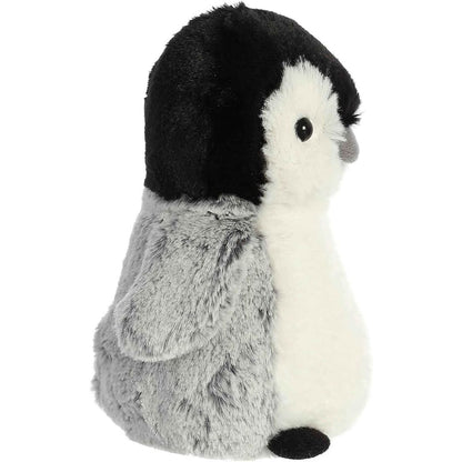 Side profile of the penguin chick stuffed animal showing its black cap, grey body fur, and small plush flipper.