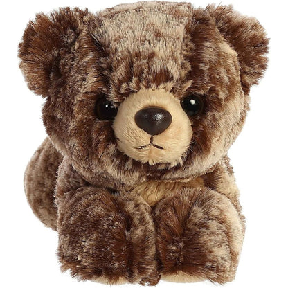 Direct front view of the soft brown plush bear lying down, highlighting its tan snout and dark nose.