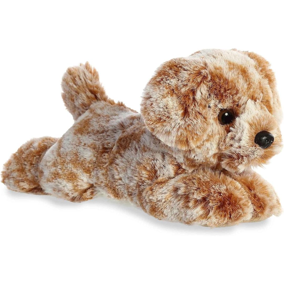 Angled side view of the Aurora Mini Flopsie Coco Lab 8-inch plush resting on its belly, featuring textured marbled brown and cream fur.