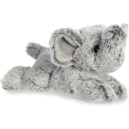 Angled side view of the Aurora Mini Flopsie Leroy Elephant 8-inch plush resting on its belly, featuring soft grey fur and an upturned trunk.