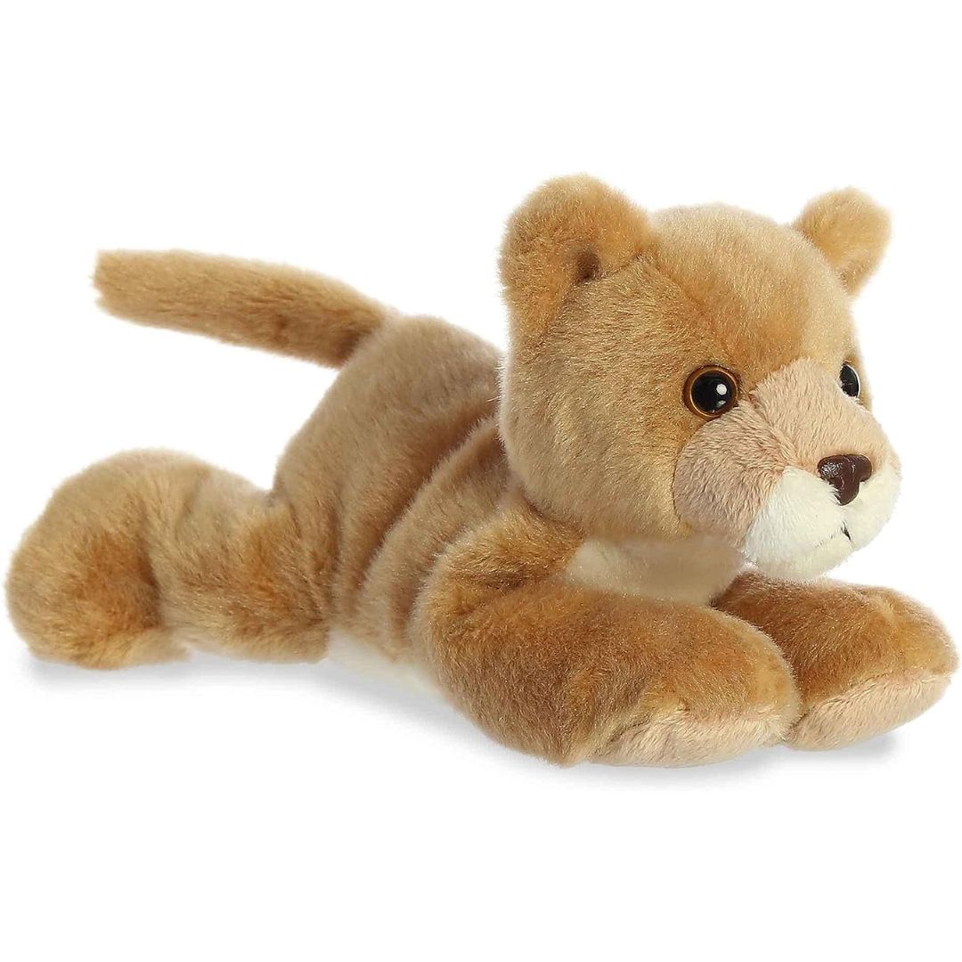 Angled side view of the Aurora Mini Flopsie Leah Lioness 8-inch plush resting on its belly, featuring soft golden-tan fur.