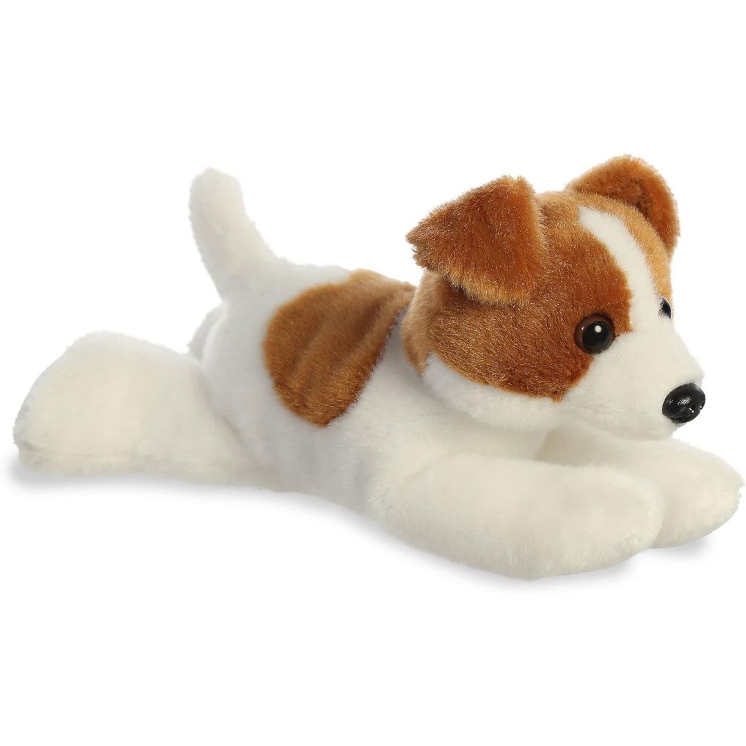 Angled side view of the Aurora Mini Flopsie Jackie Russell Terrier 8-inch plush resting on its belly, featuring white fur with brown patches.