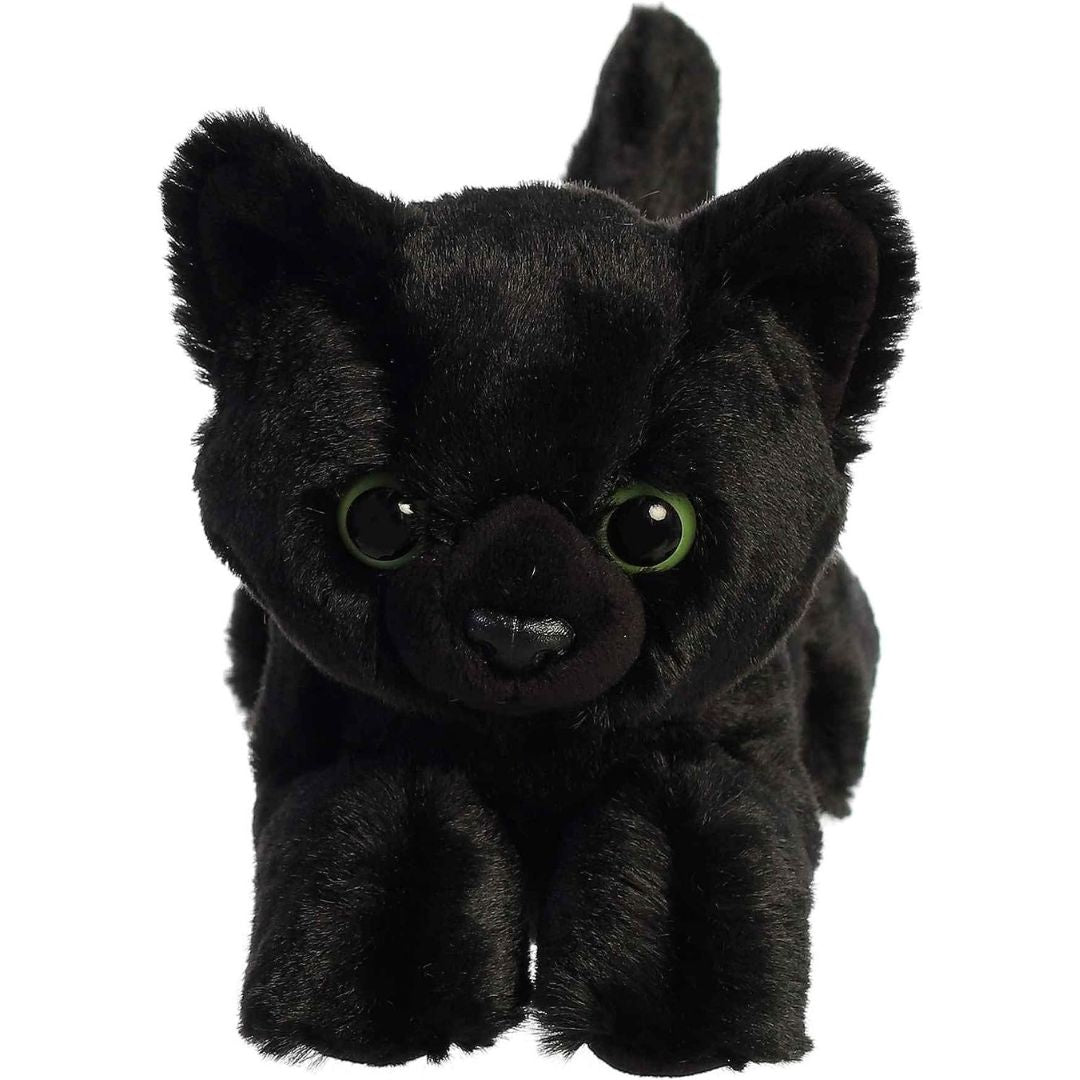 Direct front view of the soft black plush cat lying down, highlighting its bright green eyes.