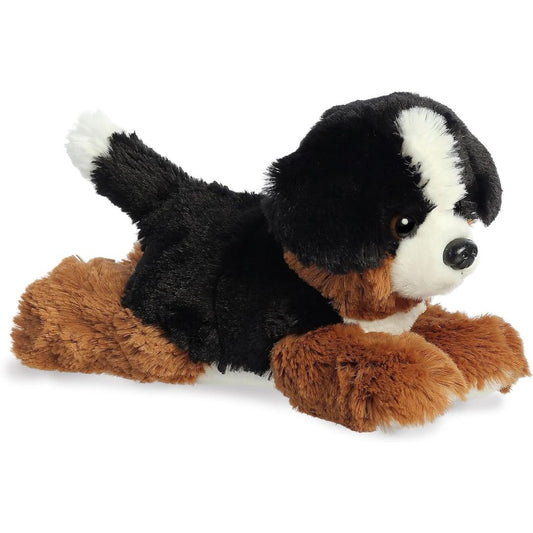 Angled side profile view of the 8-inch Aurora Mini Flopsie Bernie Mountain Dog plush resting on its belly.