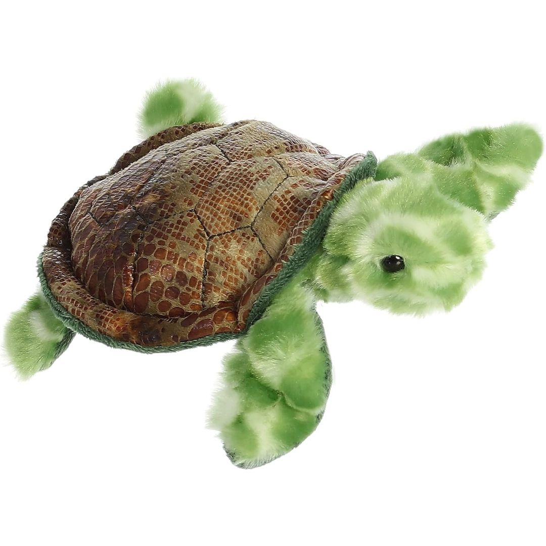 Angled view of the Aurora Mini Flopsie 8-inch Splish Sea Turtle plush resting on its belly, showing its brown shell and green flippers.