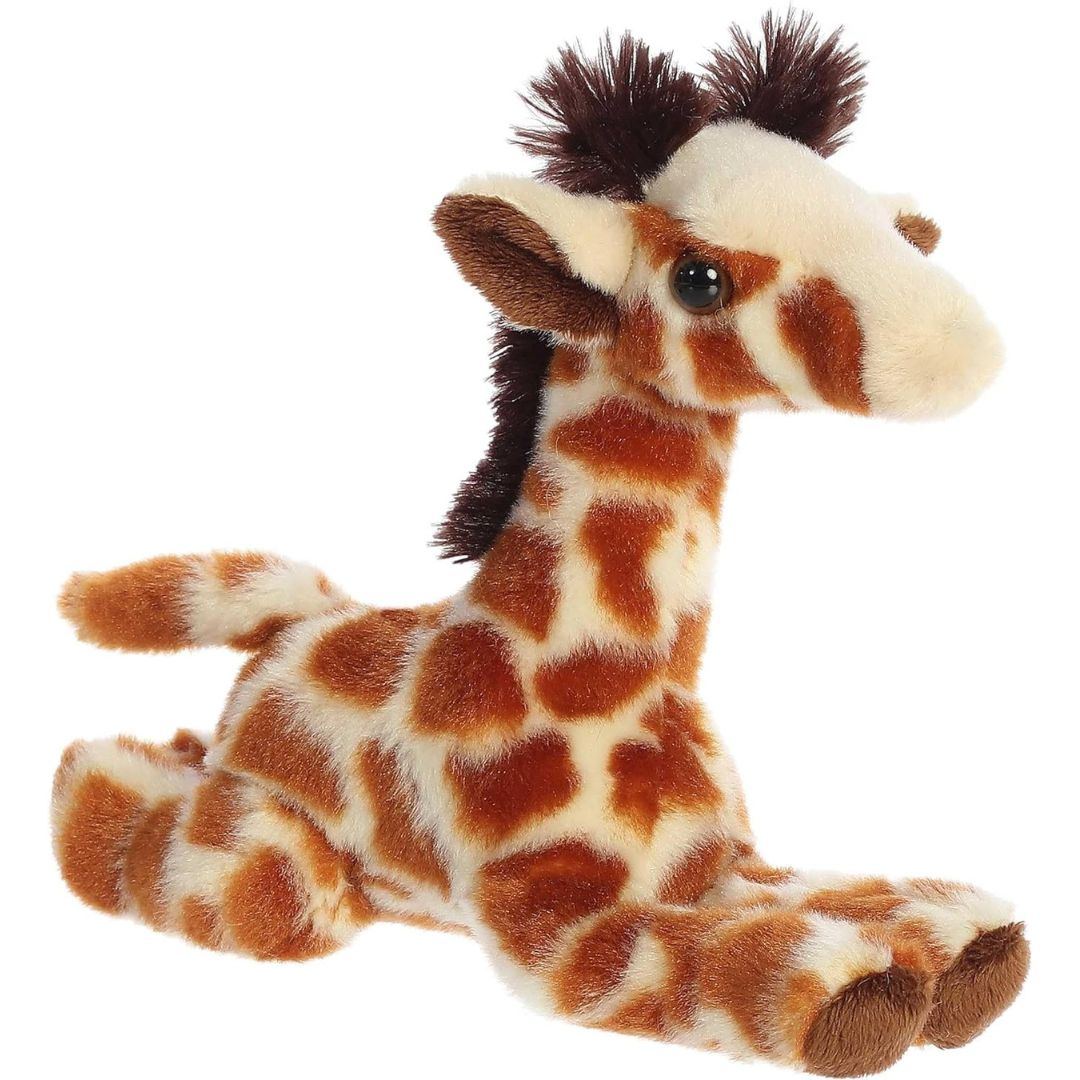 Angled front view of the 8-inch Aurora Mini Flopsie Giraffe Calf stuffed animal resting on its tummy, showing its spotted brown and cream coat and long neck.