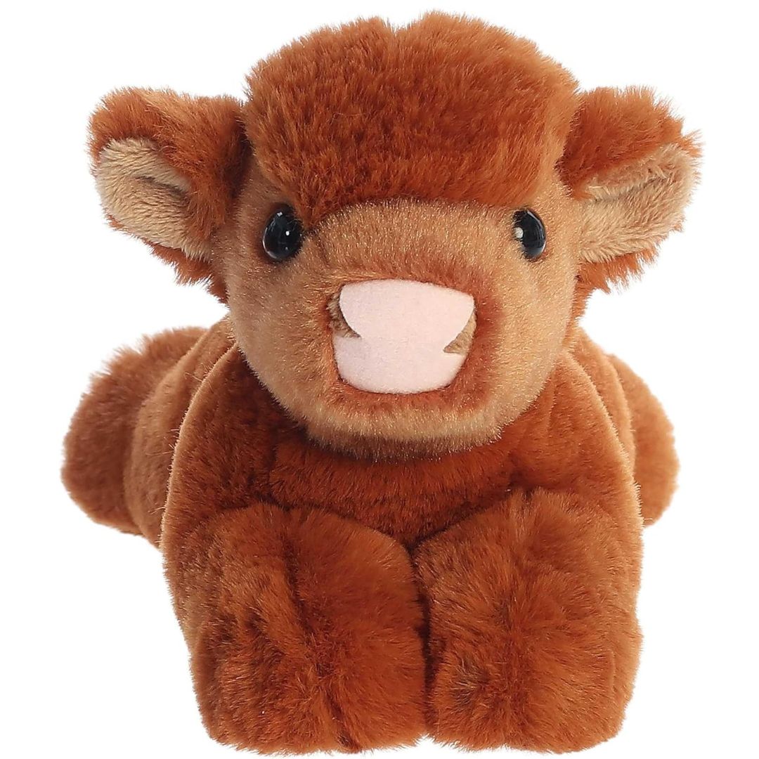 Straight-on front view of the Highland cow stuffed animal highlighting its cute pink snout and a fluffy tuft of hair on its forehead.