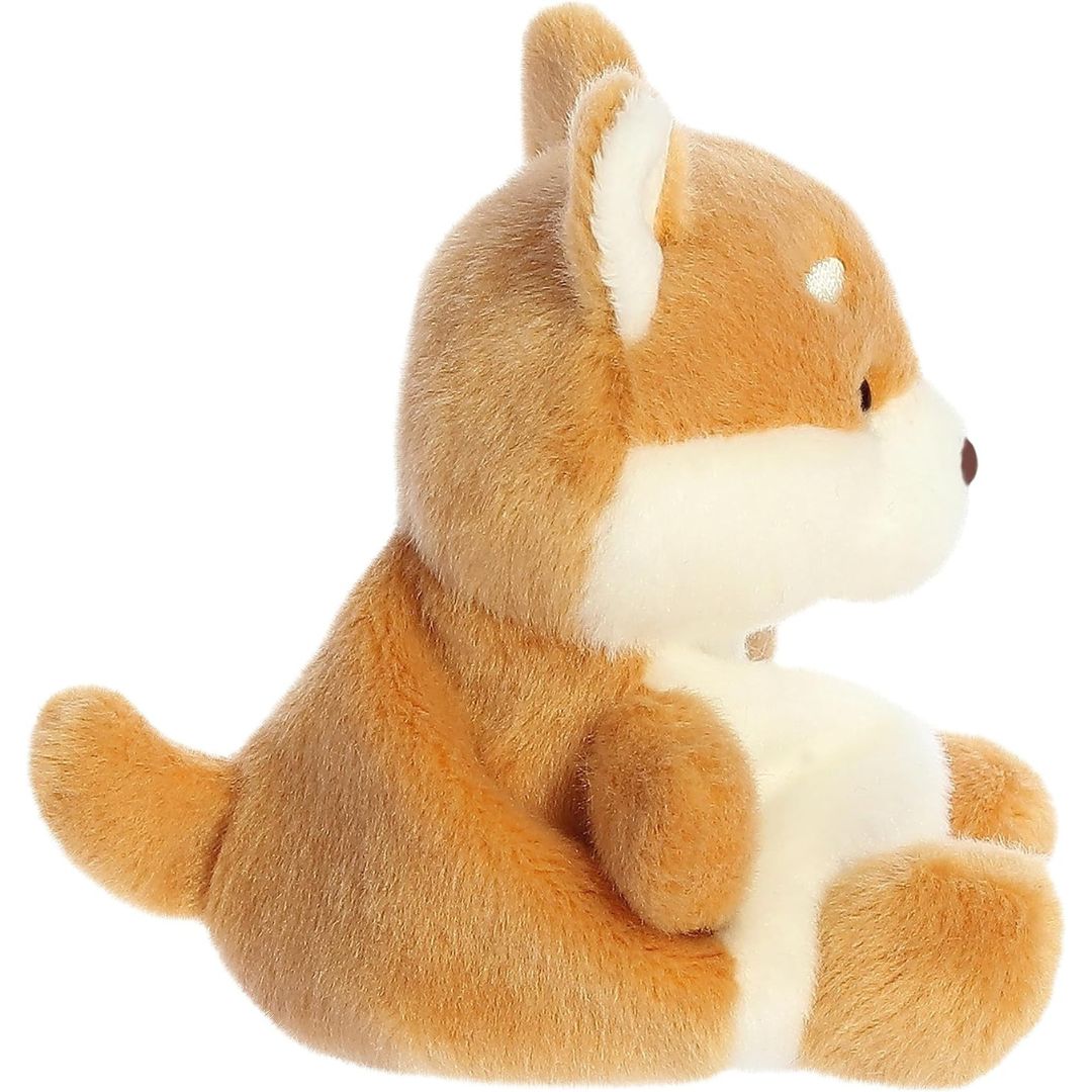 Side profile view thumbnail of the mini dog plush showcasing its rounded back, soft cream underbelly, and the curve of its small tan tail.