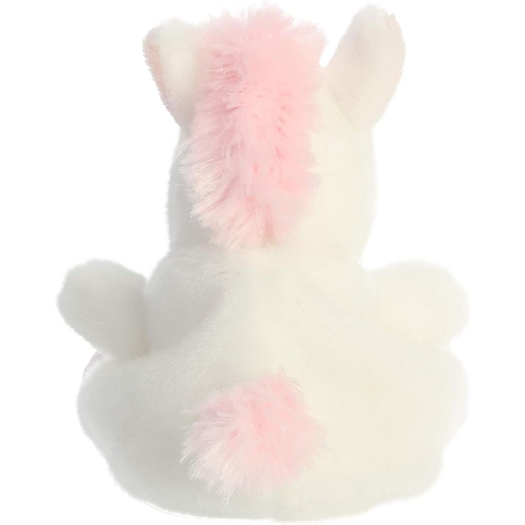 Rear view thumbnail of the Aurora unicorn stuffed toy displaying its smooth white plush backing, pink mane, and fluffy pink tail.