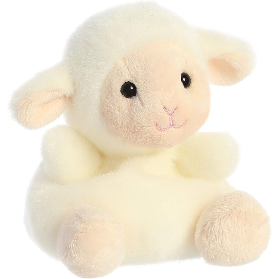 Aurora 5-inch Palm Pals Woolly Lamb plush toy sitting at an angle showing its fluffy cream fleece, contrasting peach muzzle, and floppy ears.