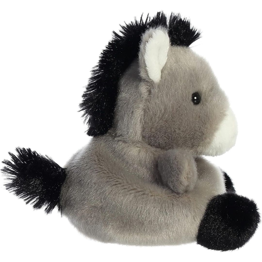 Side profile view thumbnail of the mini donkey plush showcasing its plush seated posture, spiky black mane trailing down the neck, and a fuzzy black tail.