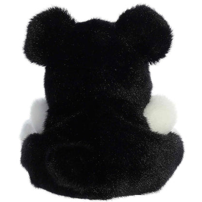 Back view of the Aurora Palm Pals dog plush toy showing its solid soft black back and black ears.