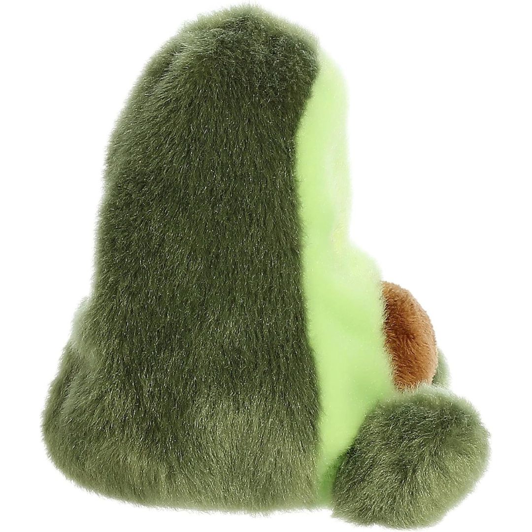 Side profile view of the Palm Pals Avocado plush highlighting its perfectly squishy body, dark green outer skin, and prominent brown belly pit.