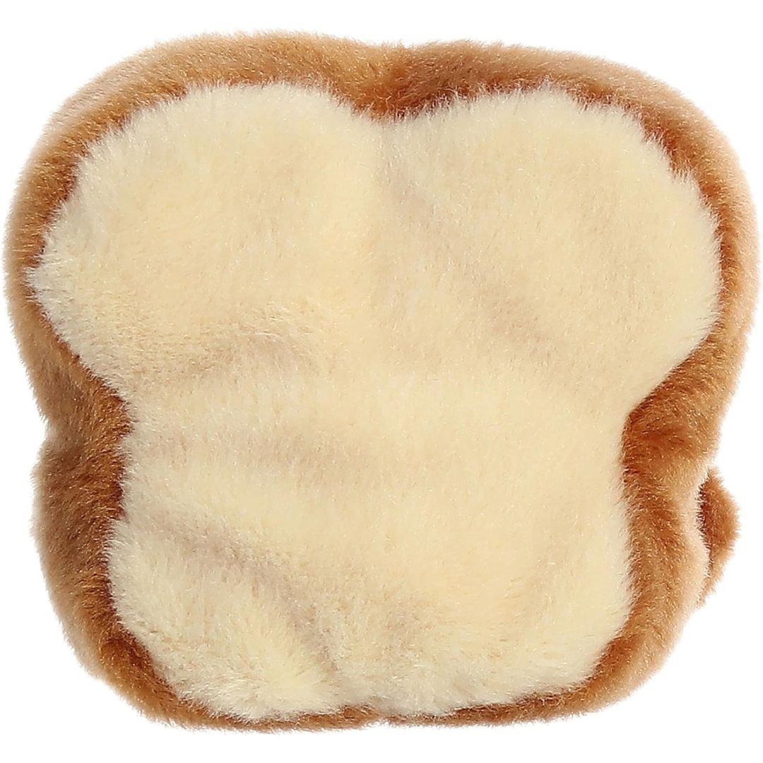 Rear view thumbnail of the Aurora toast stuffed toy displaying its plush cream-colored back surrounded by a golden-brown crust outline.