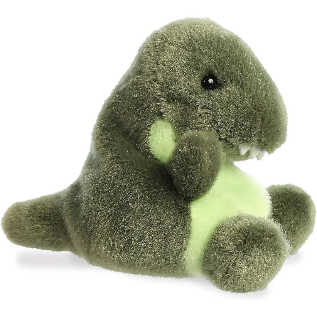 Side profile view of the Palm Pals T-Rex Dinosaur plush highlighting its perfectly squishy round body, short snout, and dark green tail.