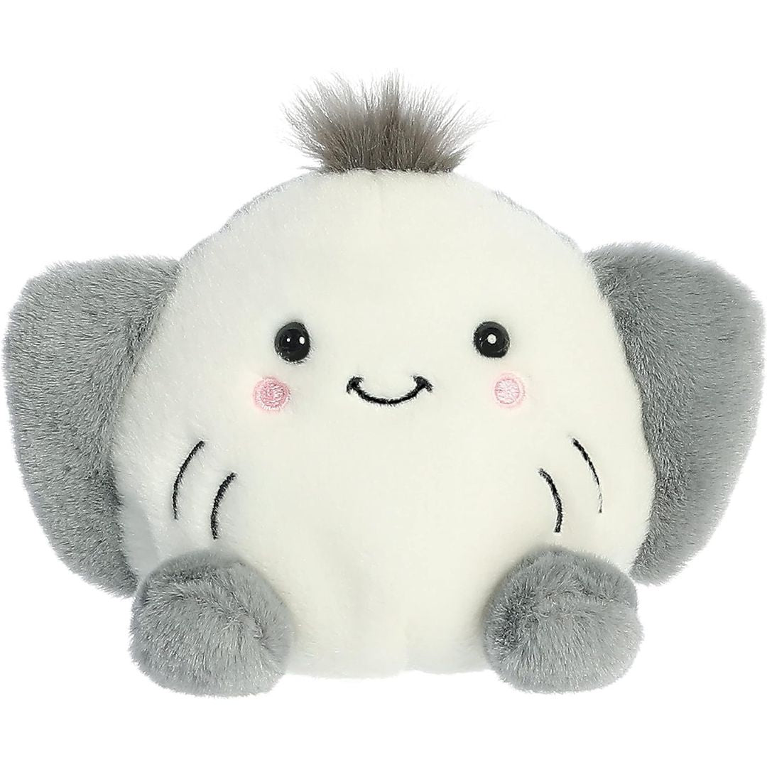 Aurora 5-inch Palm Pals Flapjack Stingray plush toy showing its round cream face with a stitched smile, rosy cheeks, outspread grey side wings, and a small spiky dark grey hair tuft on top.