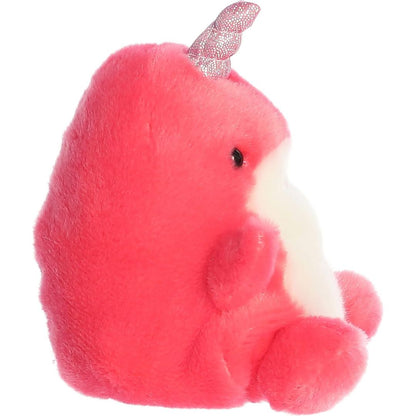 Side profile view of the mini narwhal plush showcasing its rounded hot pink back profile and the upward angle of its metallic horn.