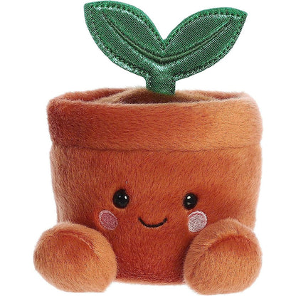 Straight-on front view of the soft brown Palm Pals potted plant plush featuring a happy face and rosy cheeks.