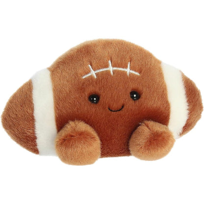 Aurora 5-inch Palm Pals Tackle Football plush toy showing its brown football shape, white end stripes, stitched laces, and a happy smiling face.