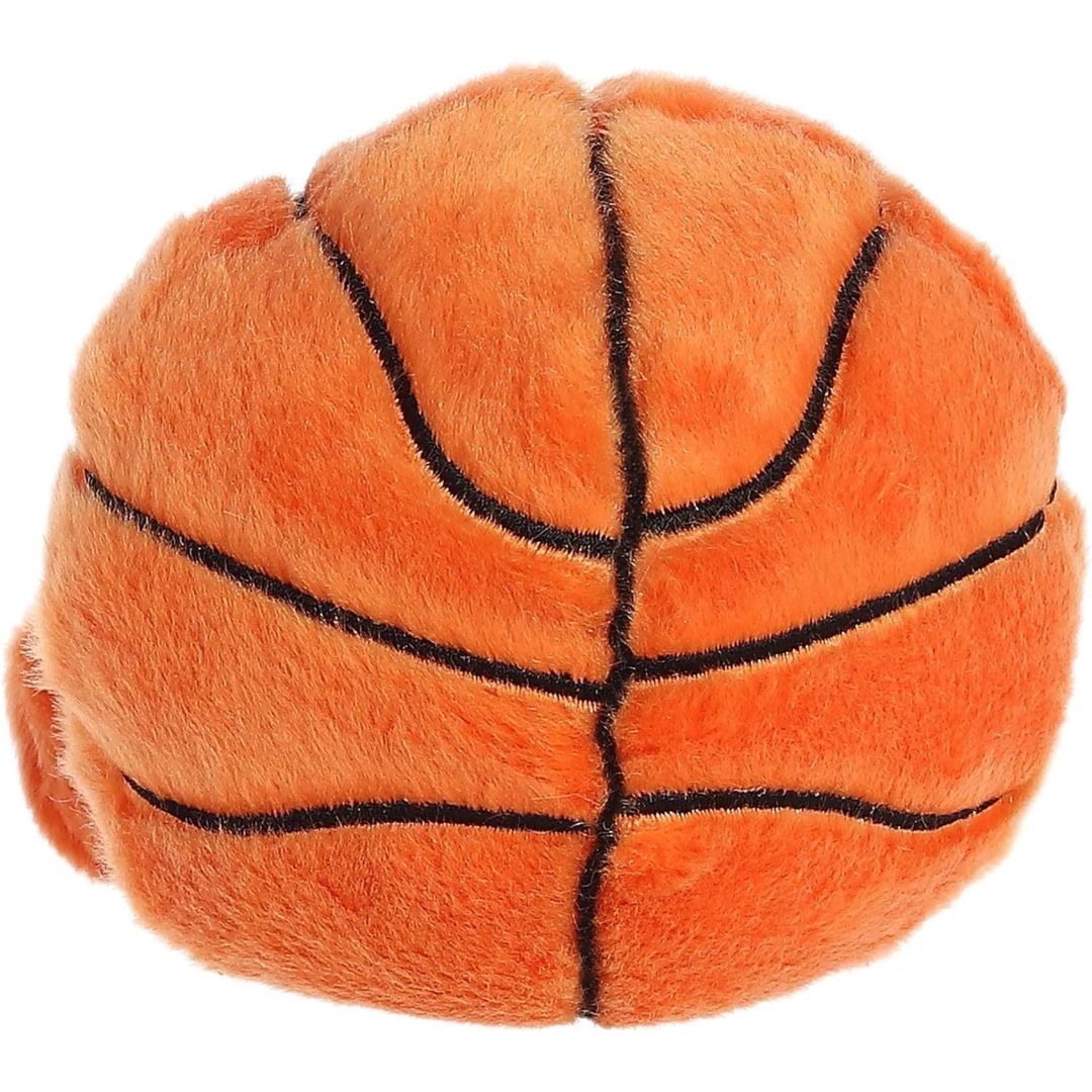 Back view of the Aurora Palm Pals Basketball plush toy showing the continuous black line details on the solid orange plush back.