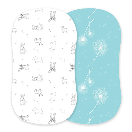 Newcastle Classics two-pack bamboo bassinet sheets showcasing the white Corgi puppy print and aqua blue dandelion print side-by-side.