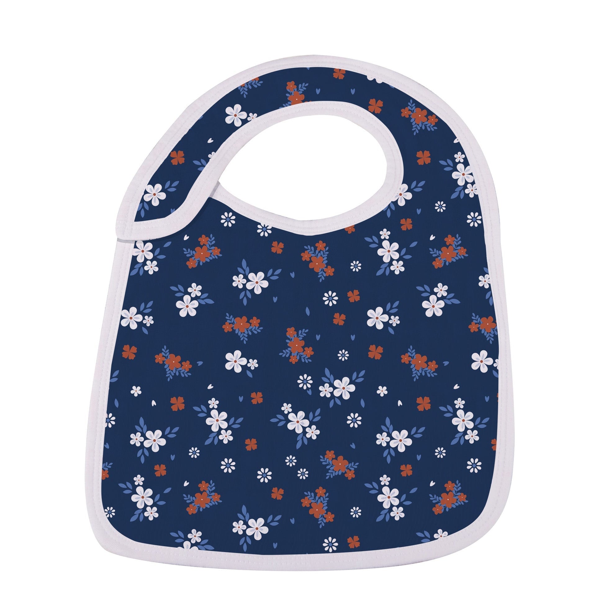 Close-up of the deep navy blue snap bib featuring a delicate white and rust-orange wildflower print.