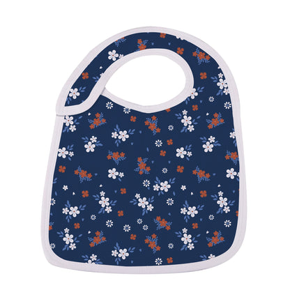 Close-up of the deep navy blue snap bib featuring a delicate white and rust-orange wildflower print.