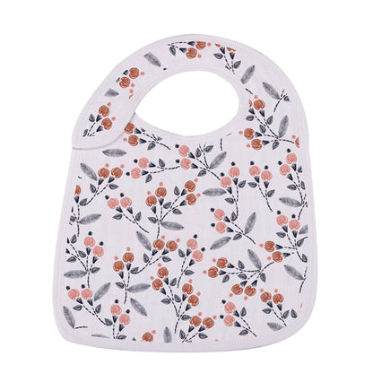 Close-up of the white bamboo muslin snap bib featuring an all-over branching botanical berry and leaf print.
