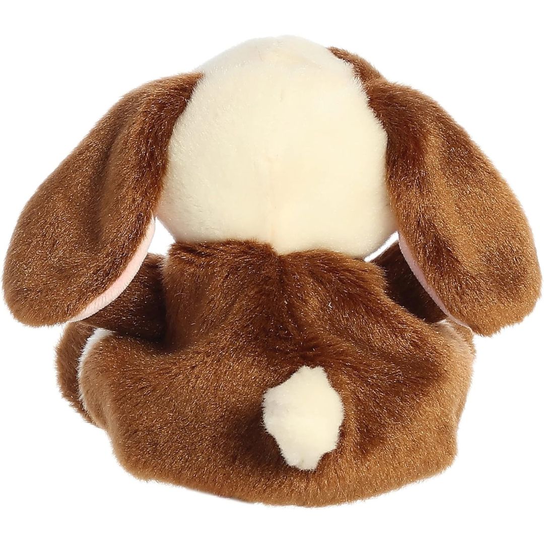 Back view of the Aurora Palm Pals bunny plush toy showing its solid brown back and a fluffy little cream cotton tail.