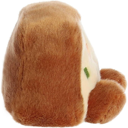 Right side profile view thumbnail of the mini holiday cake plush showcasing its wedge-like slice shape and soft brown plush crust texture.