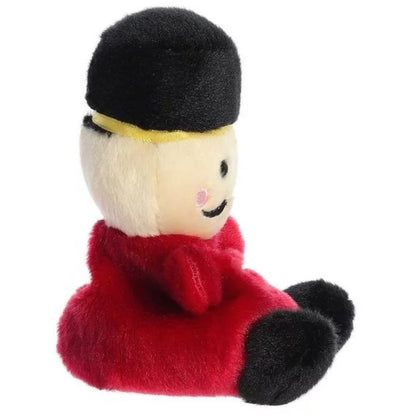 Side profile view thumbnail of the mini nutcracker plush showcasing the cylindrical black hat, rounded red uniform body, and soft seated posture.