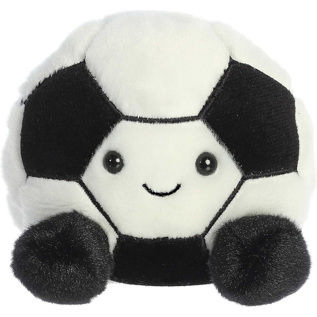 A stuffed animal toy resembling a soccer ball with a black and white design and a smiling face.