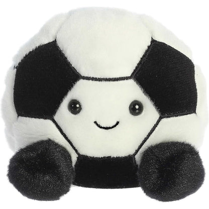 A stuffed animal toy resembling a soccer ball with a black and white design and a smiling face.