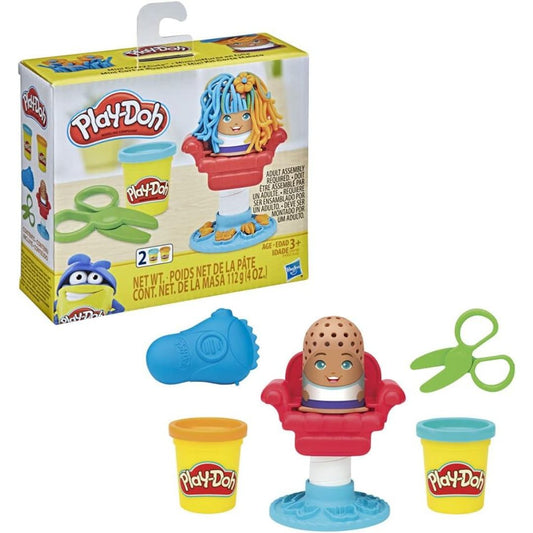 Play-Doh Mini Crazy Cuts Haircut Set packaging box next to red barber chair, character figure with colorful Play-Doh hair, green scissors, blue razor, and 2 compound cans.